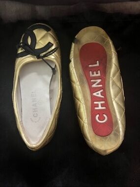 CHANEL Gold Quilted Leather Ballet Flats with Black Bow Accent